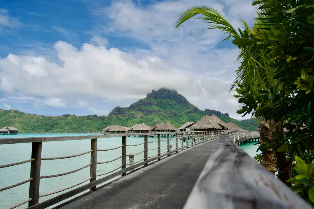Stunning view of overwater bungalows with a mountain backdrop in Bora Bora, French Polynesia.