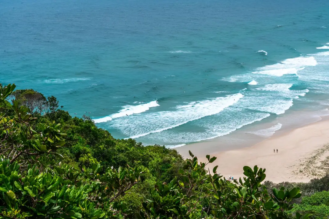 Explore the beautiful sandy beaches and vibrant greenery of Byron Bay from above with this stunning coastal shot.