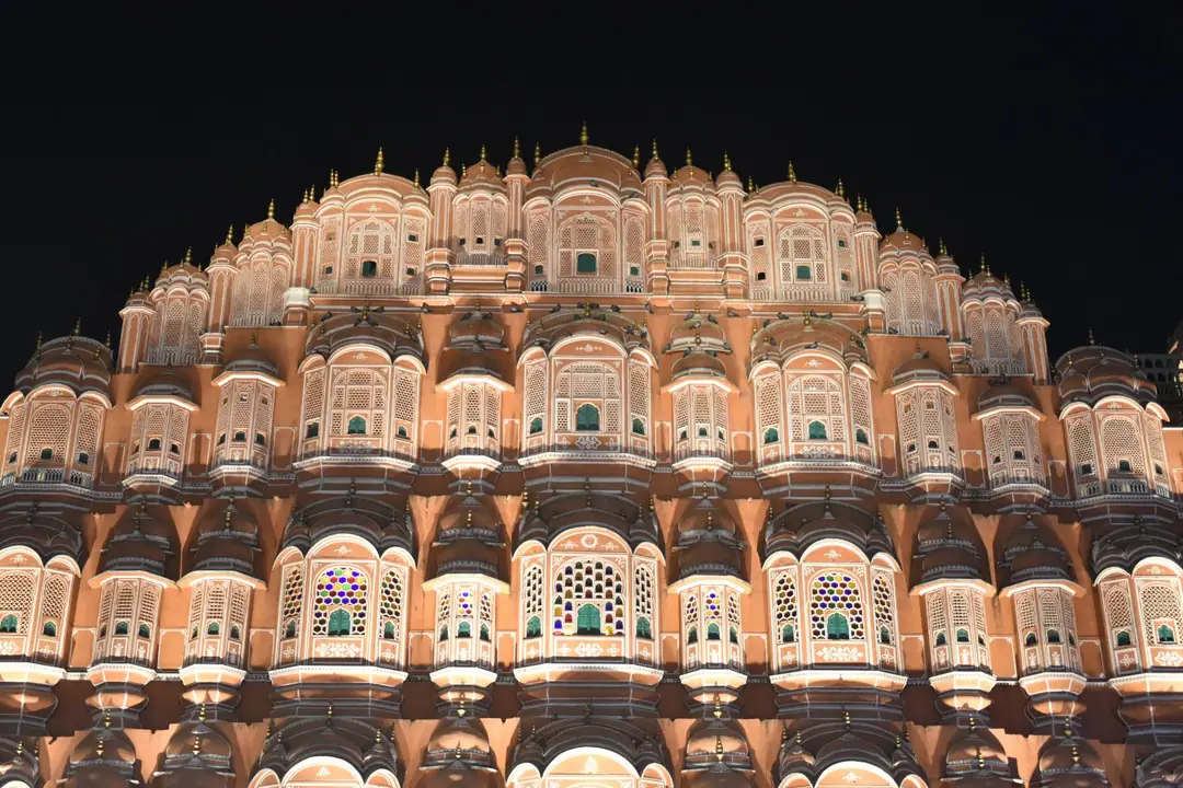 Majestic night view of Hawa Mahal, Jaipur's iconic architectural marvel, beautifully illuminated.