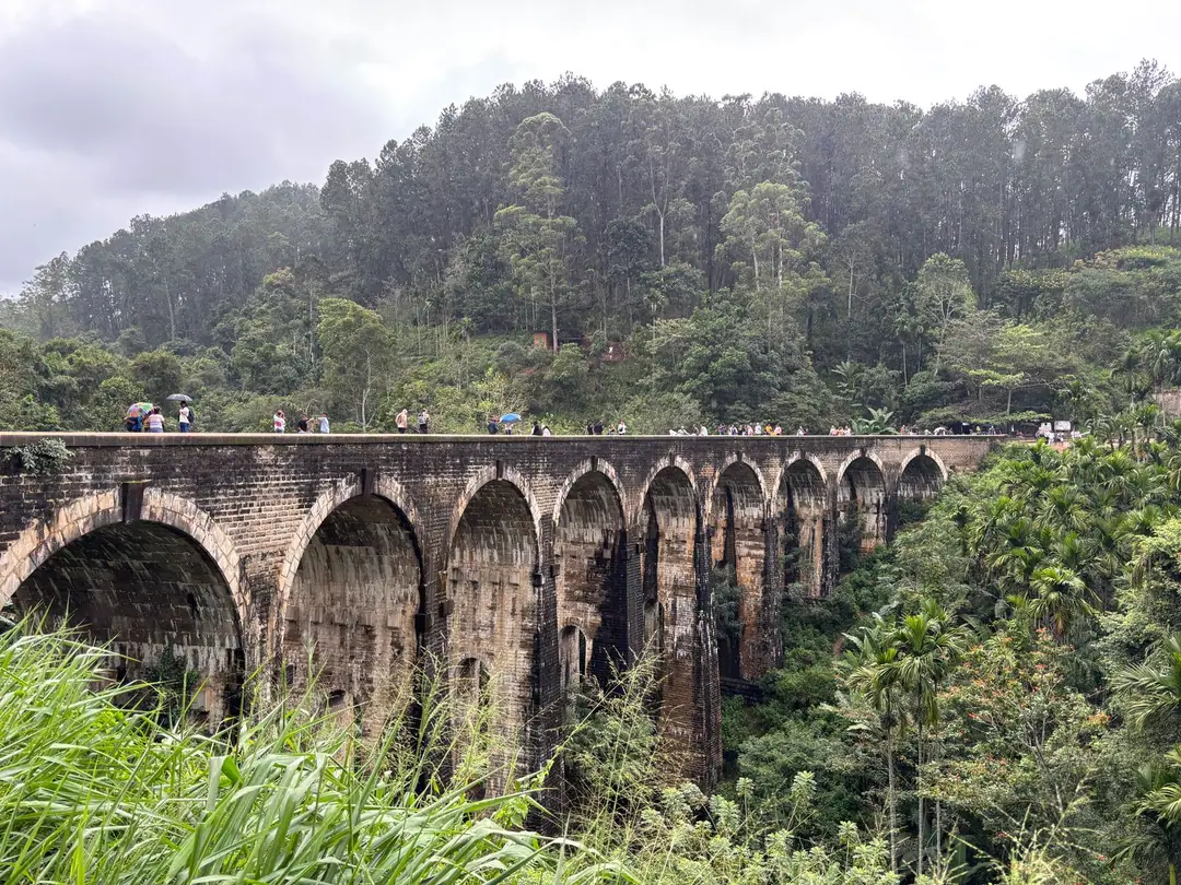 Scenic view of Nine Arches Bridge amidst lush greenery in Ella, Sri Lanka.